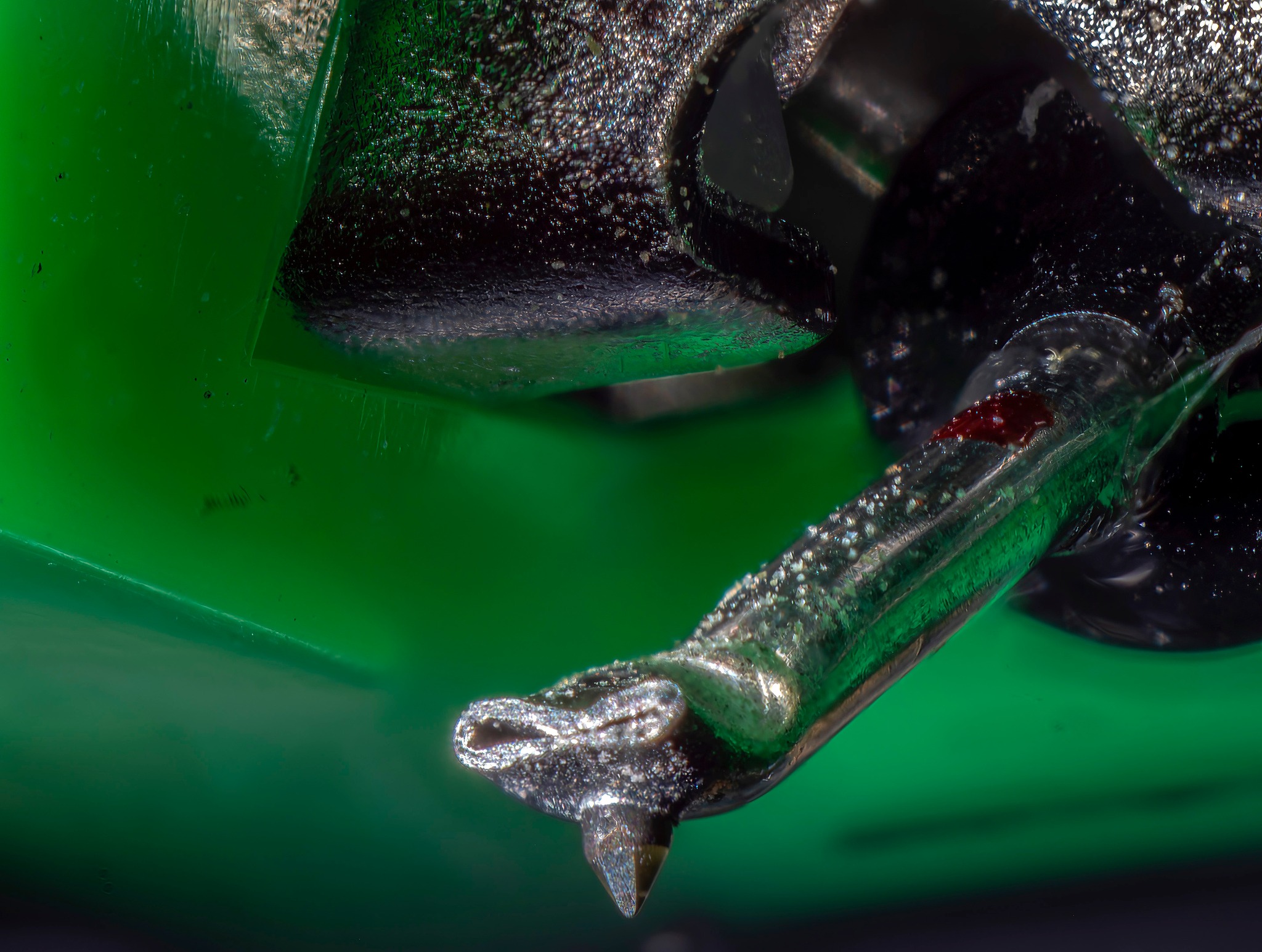 A very close-up view of a record player needle.