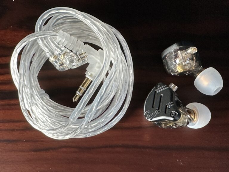 Wired earbuds with a clear wire coiled next to the in-ear part.