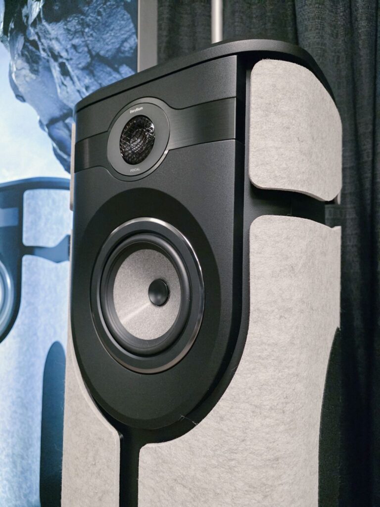 Closeup of a tweeter and woofer on a speaker with gray and black trim.