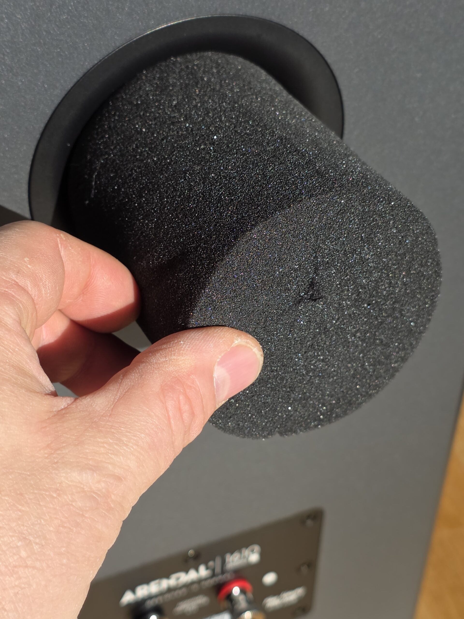 Inserting a foam port plug into the Arendal Sound 1610 Bookshelf 8