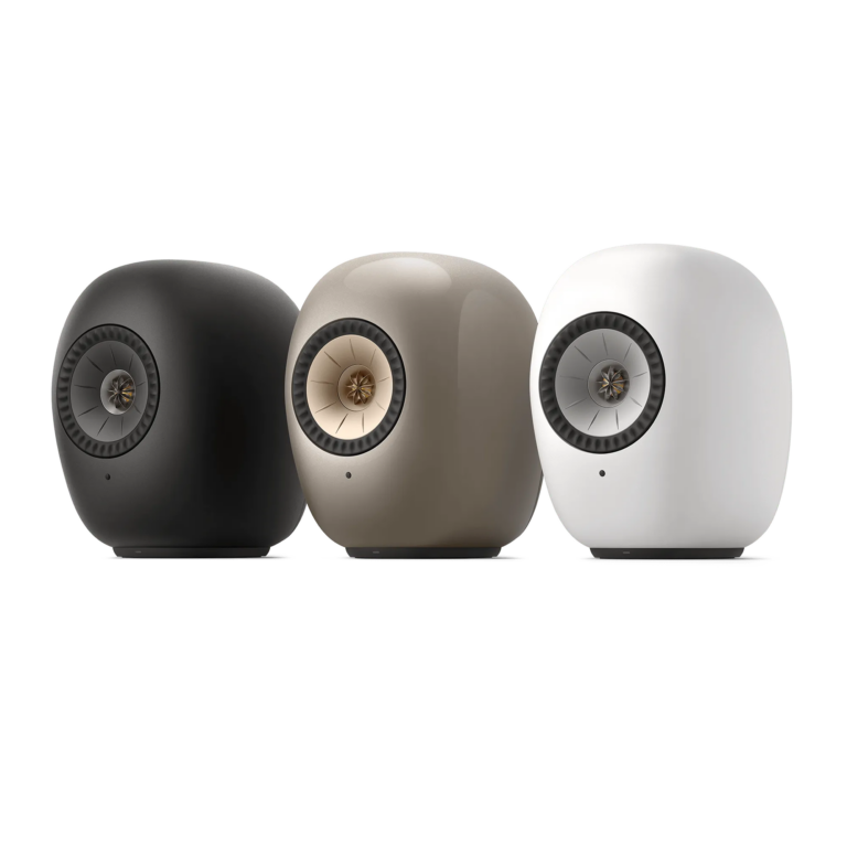 Three KEF LS LUXE wireless speakers shown in Eclipse Black, Dusk Titanium, and Mineral White.