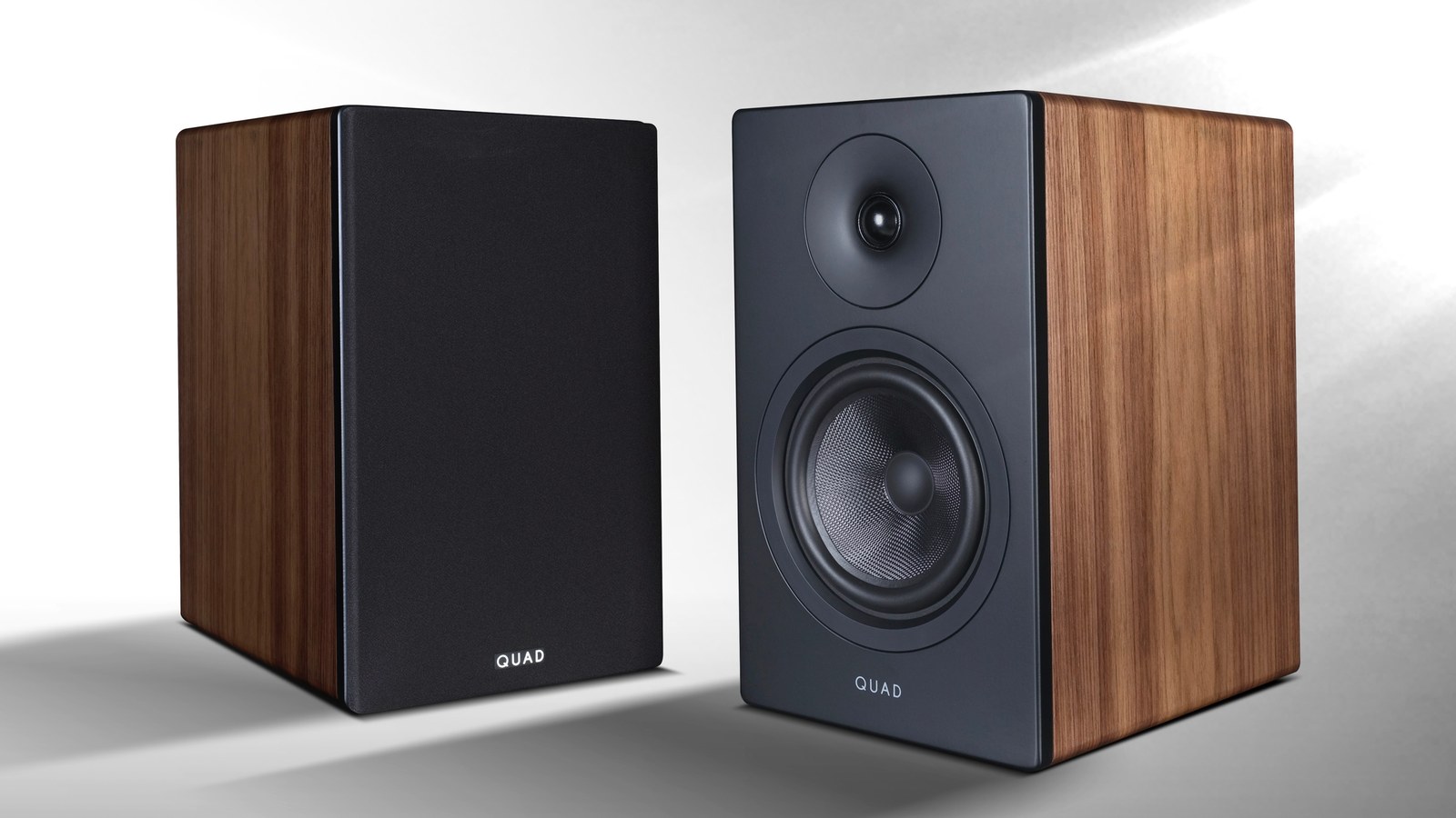 Pair of QUAD ELEGAN 1 standmount loudspeakers in walnut veneer, one with grille and one without