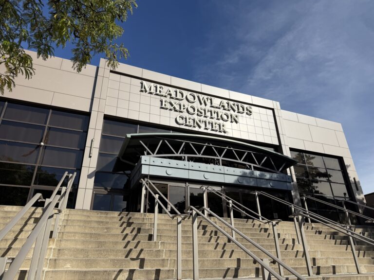 Exterior of the Meadowlands Exposition Center, with its sign above the entrance and stairs.