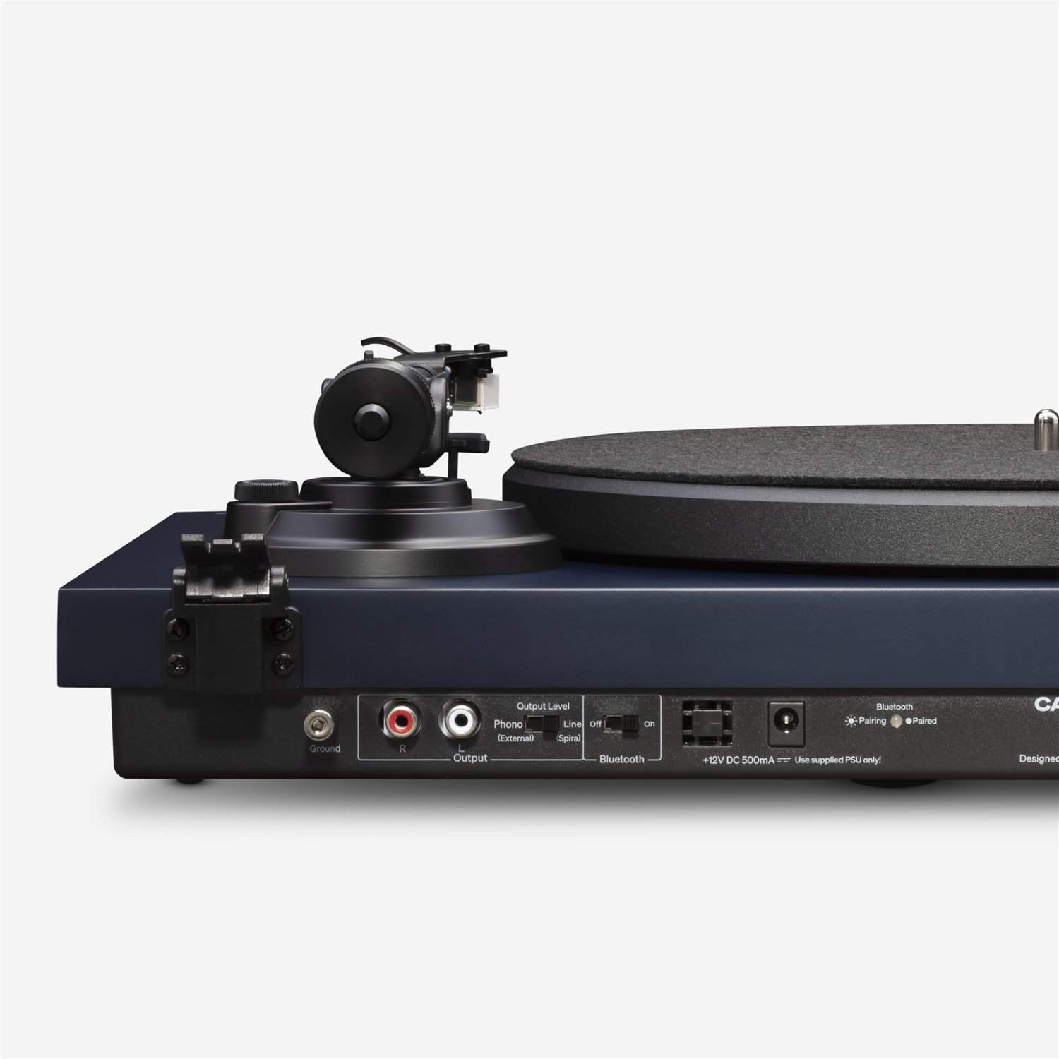 Rear view of Navy Blue Cambridge Audio Spira turntable showing ground screw, RCA output jacks, Line/Phono switch, Bluetooth switch and LED, 12V DC input, and power switch