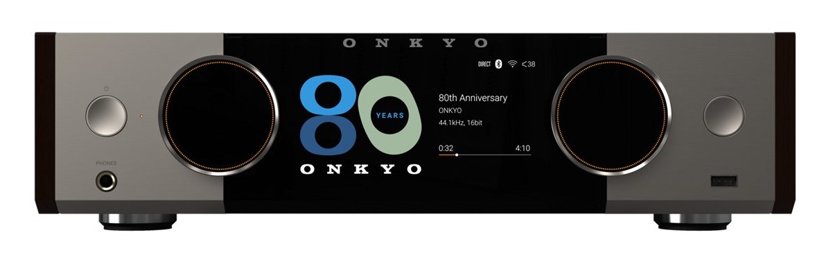 Front view of the Onkyo Muse Y-50 80th Anniversary Special Edition showing the Champagne Gold aluminum faceplate, Bordeaux walnut side cheeks, and 5.46-inch LCD displaying dual analog-style VU meters
