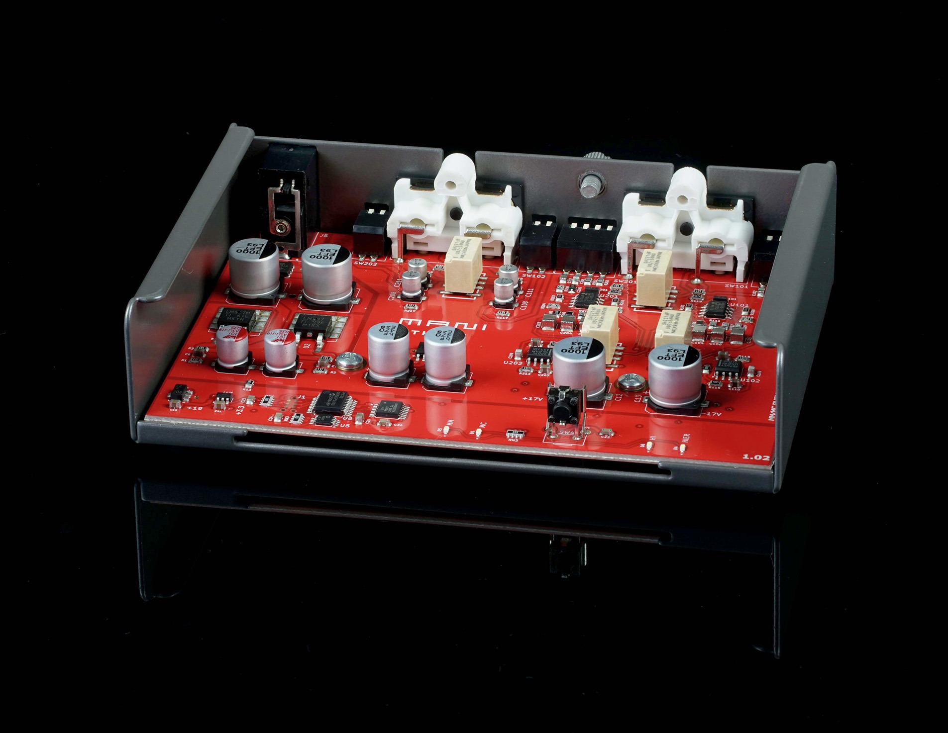 Internal circuit board of the Schiit Mani 3 phono stage showing sealed relays, precision film capacitors, thin-film resistors, dual-filtered linear power supply rails, and Analog Devices AD4898 gain stages