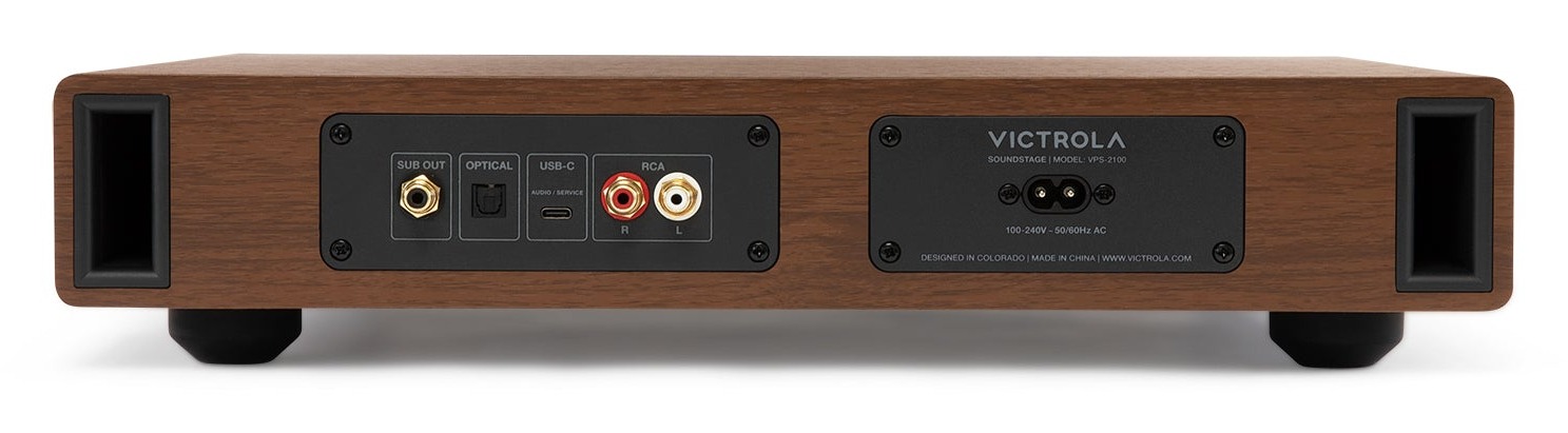 Rear view of the Walnut Victrola Soundstage showing dual bass ports, subwoofer output, optical input, USB-C port, stereo RCA inputs, and AC power inlet